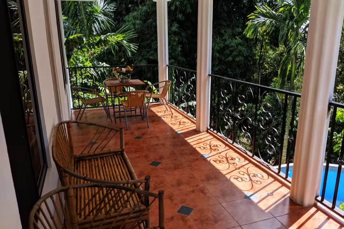 Spacious main balcony at Villa Sulterra overlooking the pool, creek, and tropical rainforest in Pérez Zeledón, Costa Rica